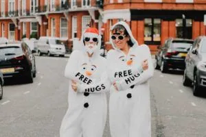 Two women in festive jumpsuits – snowman