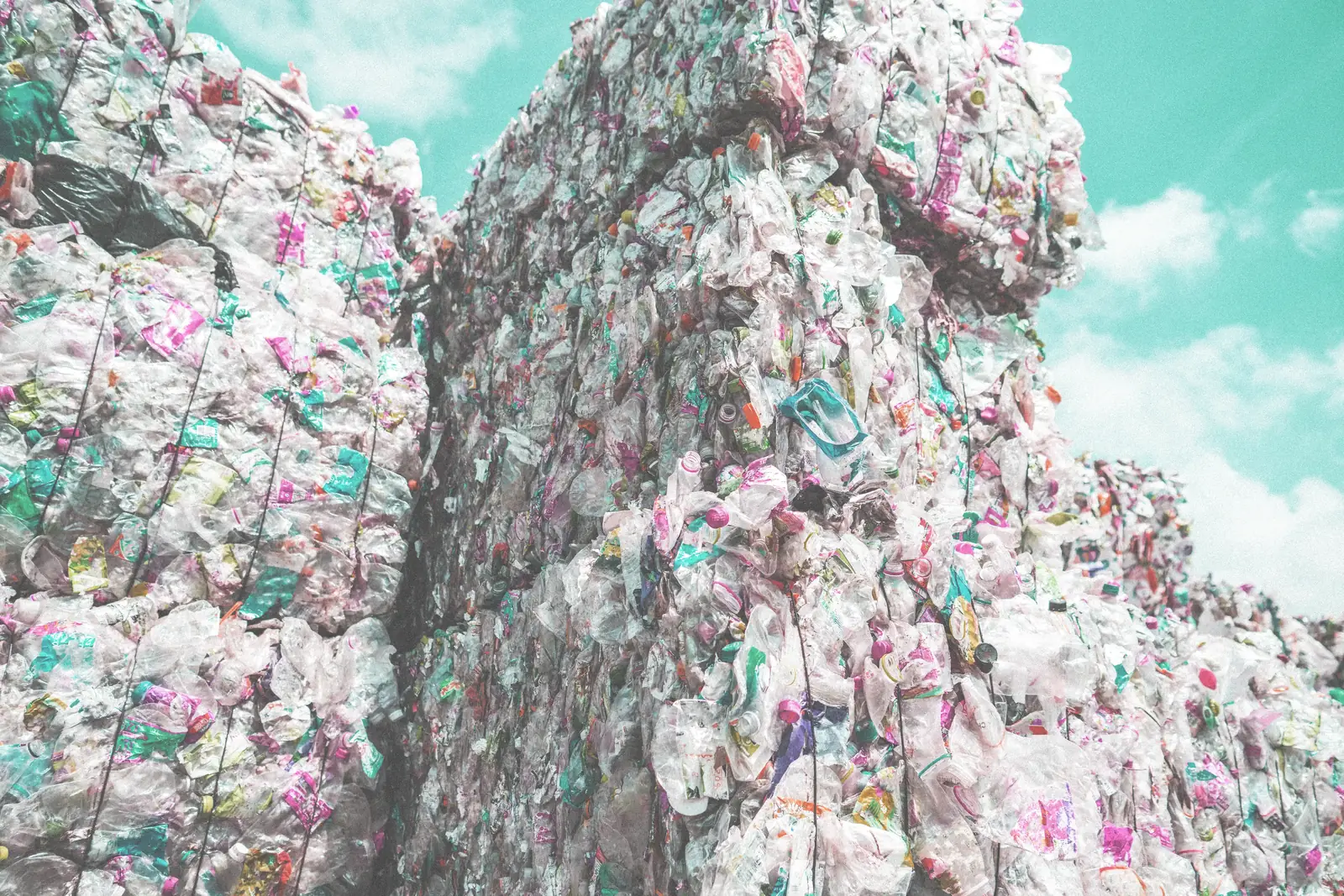 Stacked bales of compressed plastic waste at a sorting facility