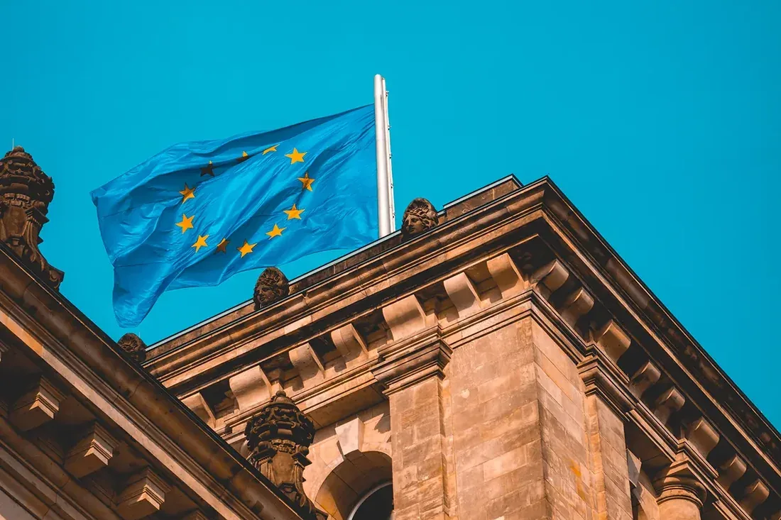 European union flag waving on building roof